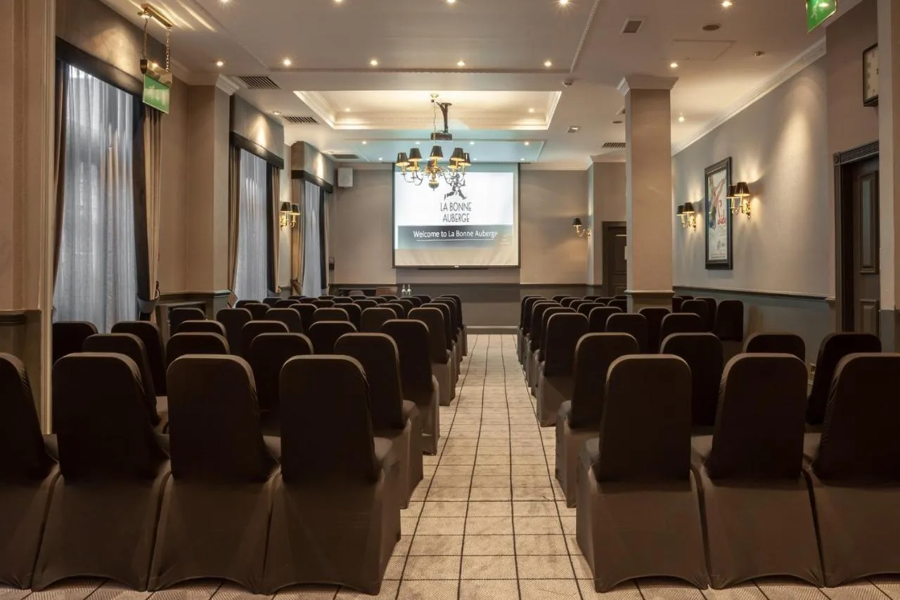a lecture hall with chairs and a screen at Holiday Inn Glasgow City Theatreland by IHG in Glasgow