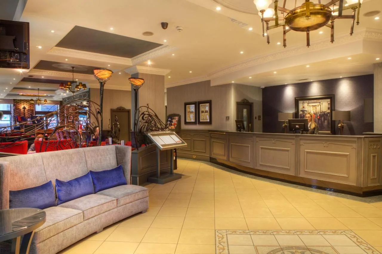 a waiting room with a couch in a salon at Holiday Inn Glasgow City Theatreland by IHG in Glasgow